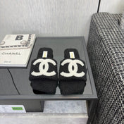 CHANEL 26S SLIDE SANDALS IN BLACK SHEARLING AND WHITE CC LOGO SQUARE TOE